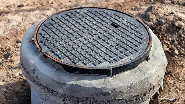 mounting-heavy-cast-iron-sewer-hatch-concrete-well-close-up-modern-sewerage-water-supply-city_331695-2764.jpg